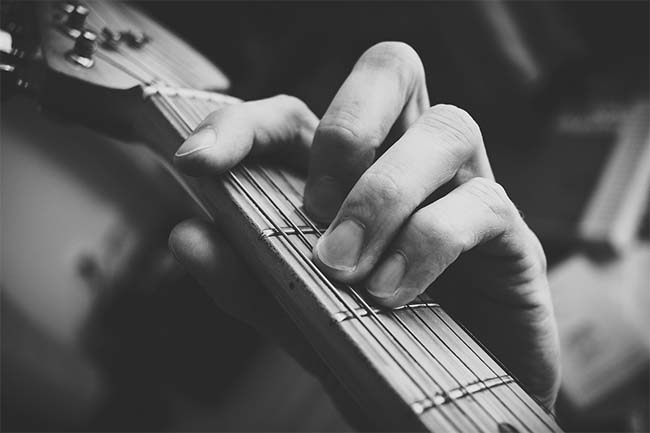 Man Playing Guitar Chord: Black and White Man Playing Guitar Chord: Black and White
